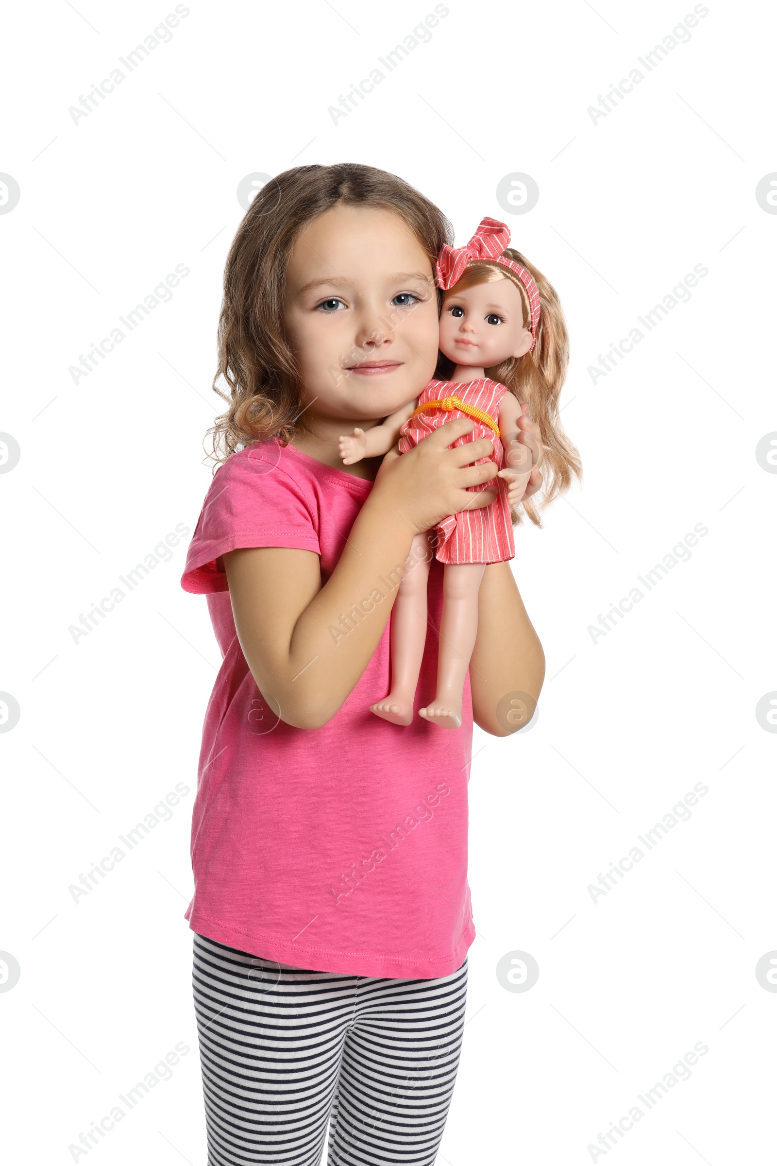 Photo of Cute little girl holding doll on white background