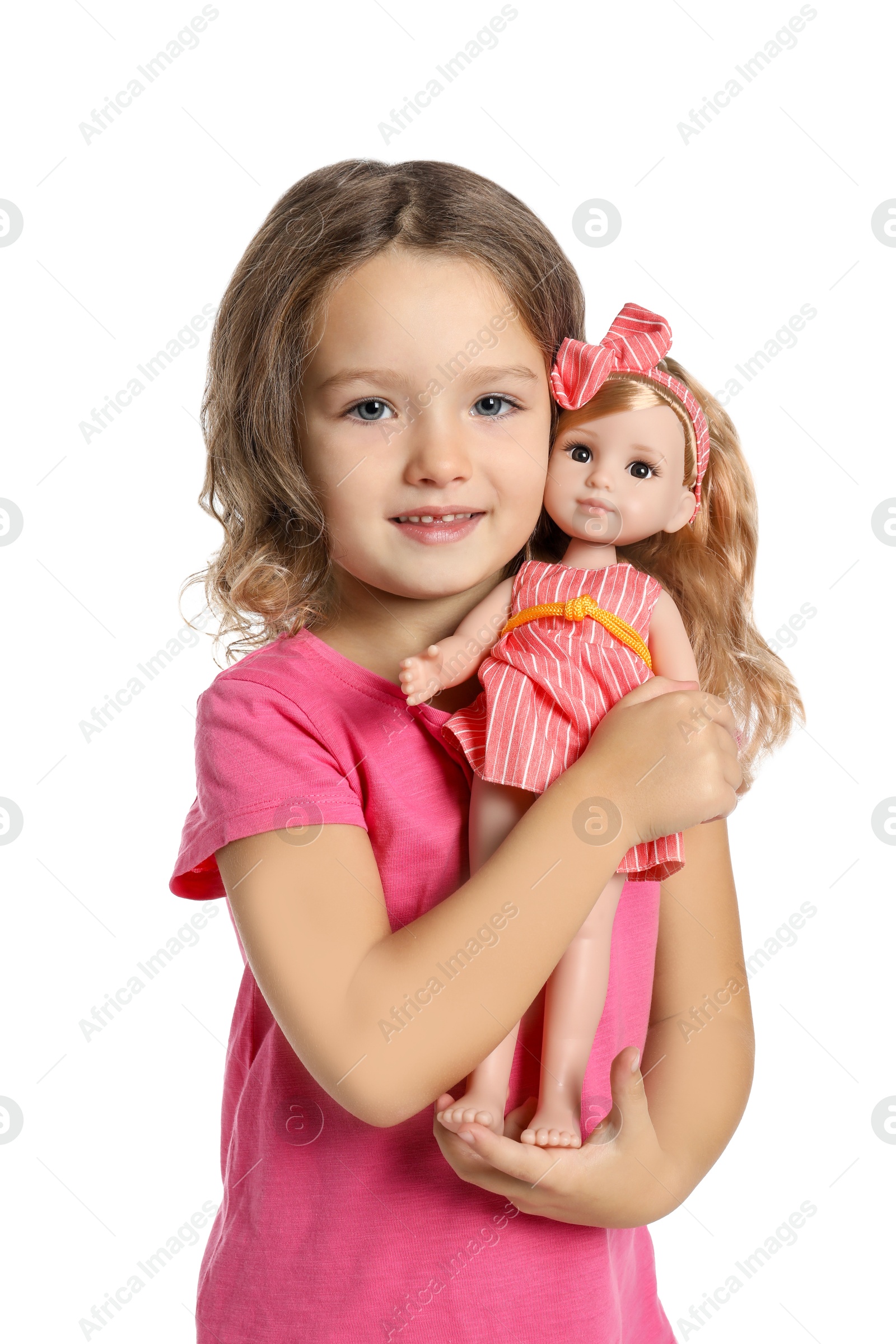 Photo of Cute little girl holding doll on white background