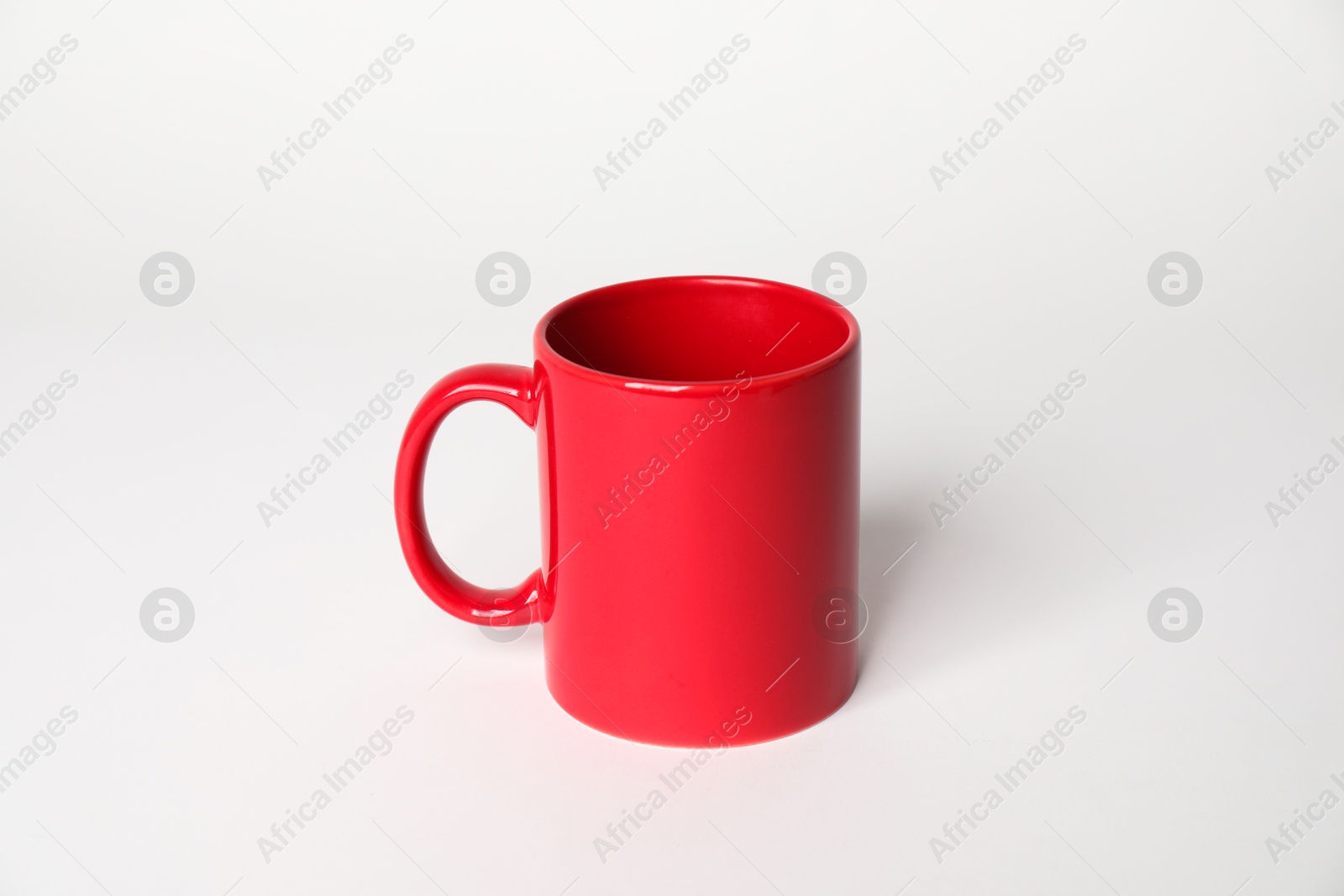 Photo of Red ceramic mug on white background. Mockup for design