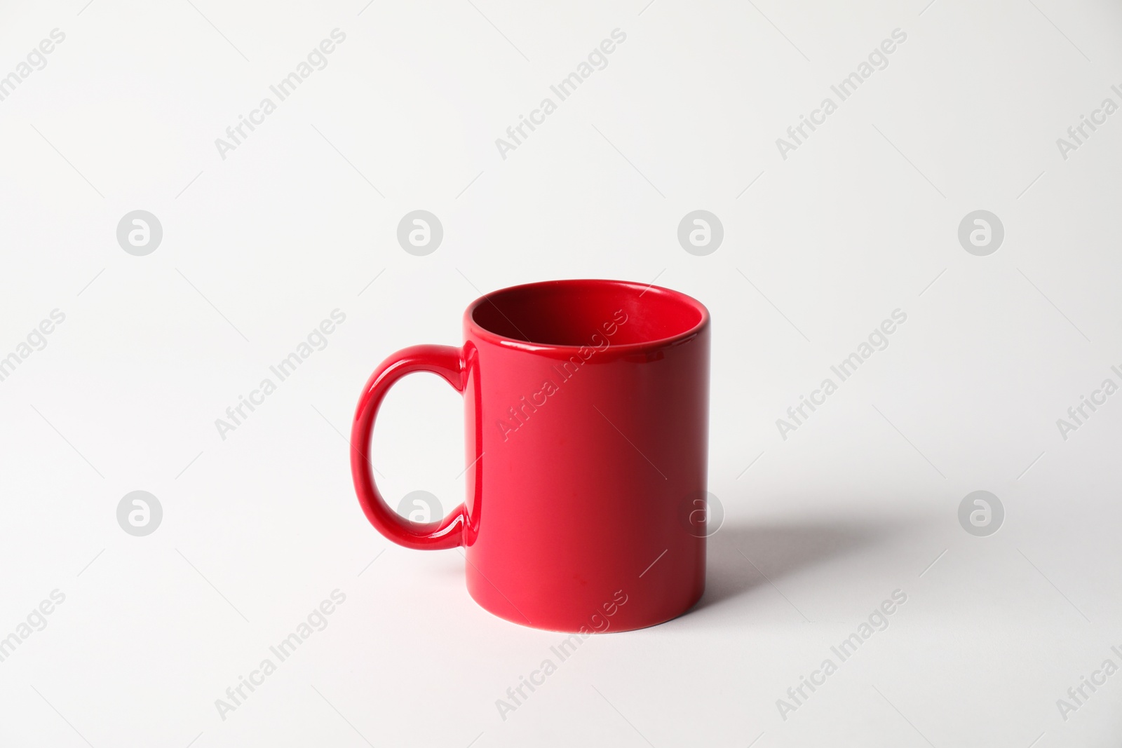 Photo of Red ceramic mug on white background. Mockup for design