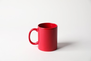 Photo of Red ceramic mug on white background. Mockup for design