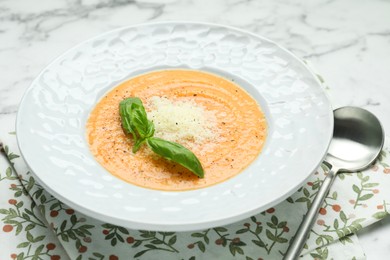 Photo of Delicious sweet potato soup served on white marble table, closeup
