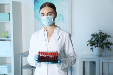 Photo of Laboratory testing. Doctor with blood samples indoors