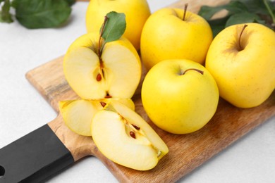 Ripe yellow apples on light grey table, closeup