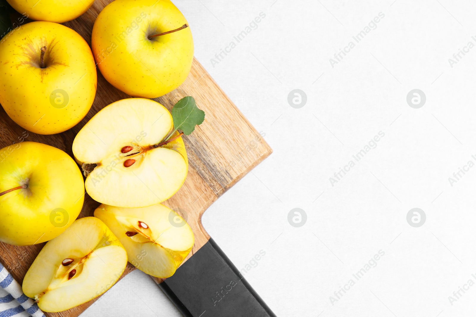 Photo of Ripe yellow apples on light grey table, top view. Space for text