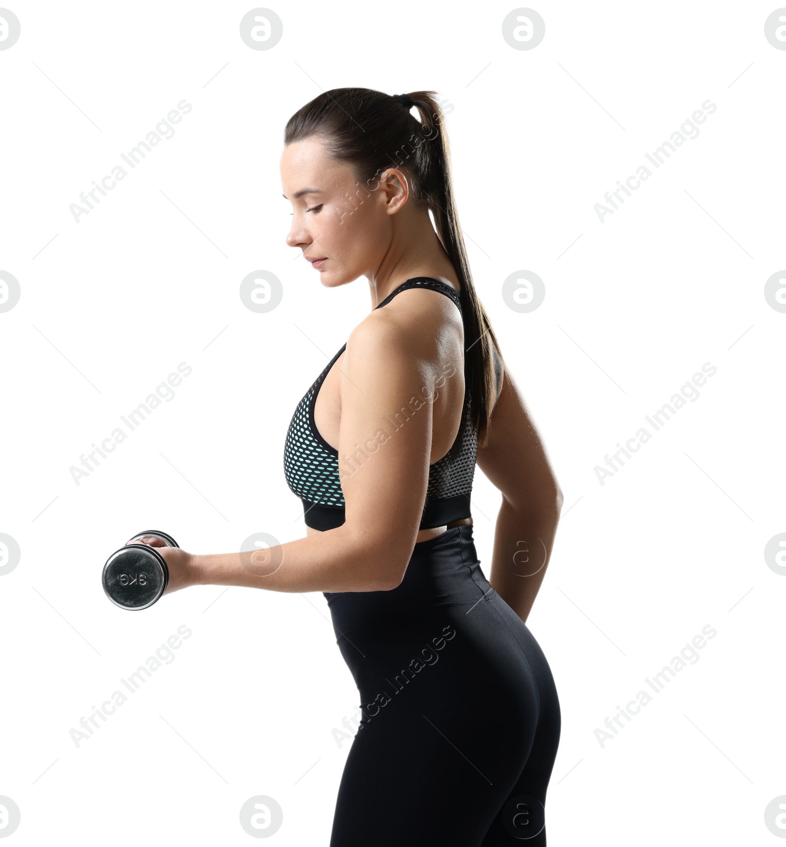 Photo of Beautiful woman in sportswear training with dumbbells on white background