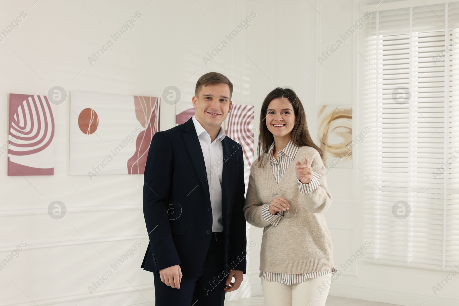 Photo of Happy woman and man visiting art gallery