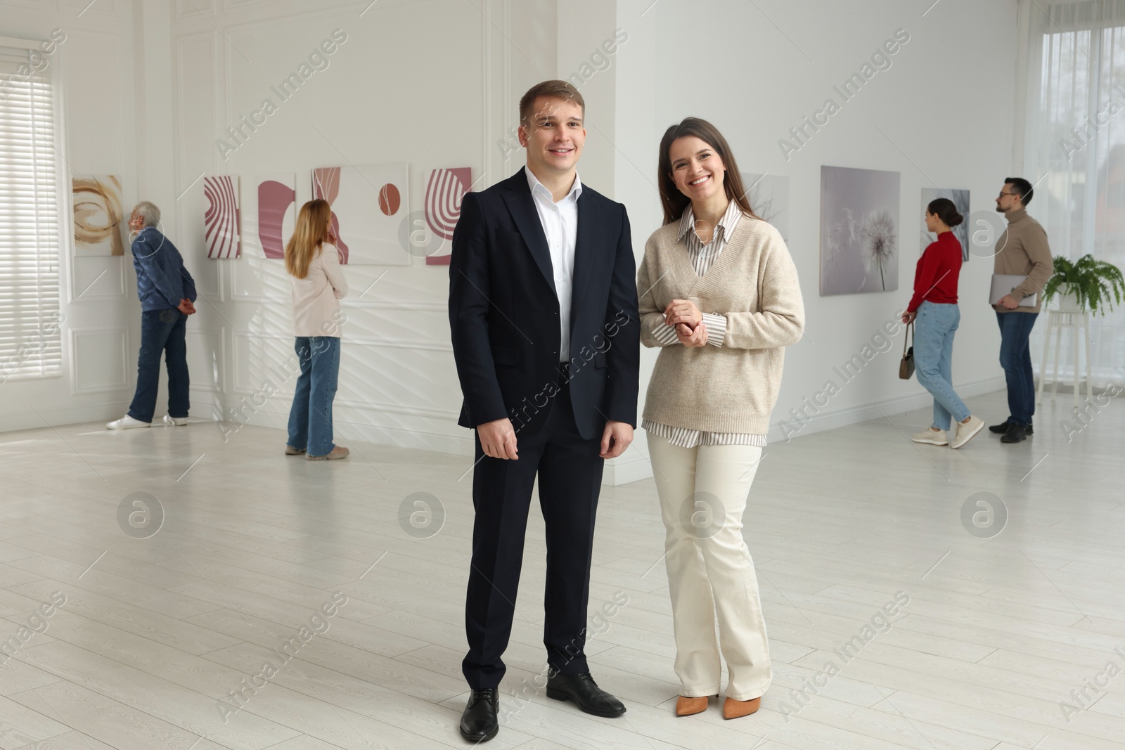 Photo of Happy woman and man visiting art gallery