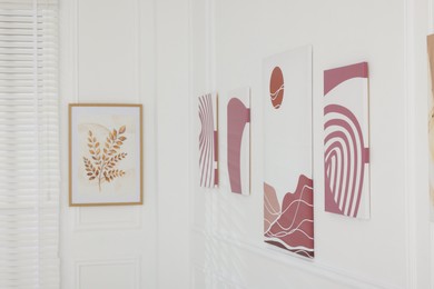 Photo of Beautiful paintings on wall in art gallery