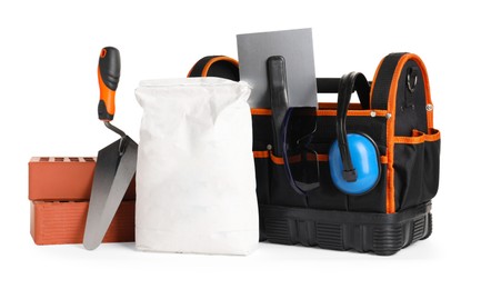 Photo of Bag with construction tools and building materials isolated on white