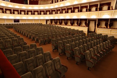 Photo of Rows of gray comfortable seats in theatre