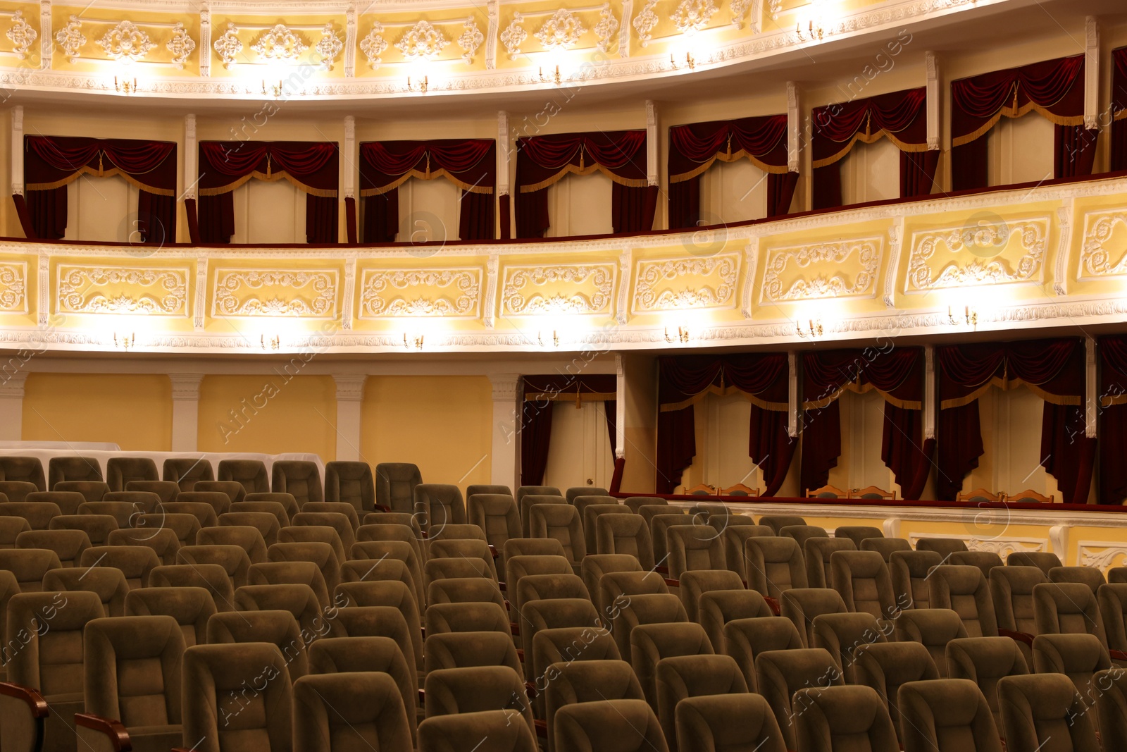 Photo of Rows of gray comfortable seats in theatre