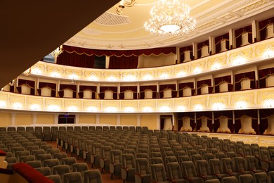 Photo of Rows of gray comfortable seats in theatre