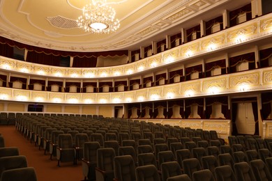 Rows of gray comfortable seats in theatre