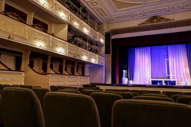 Photo of Theatre interior with stage and rows of comfortable seats