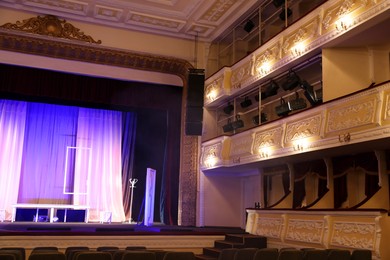 Photo of Stage with decorations and professional spotlights in theatre