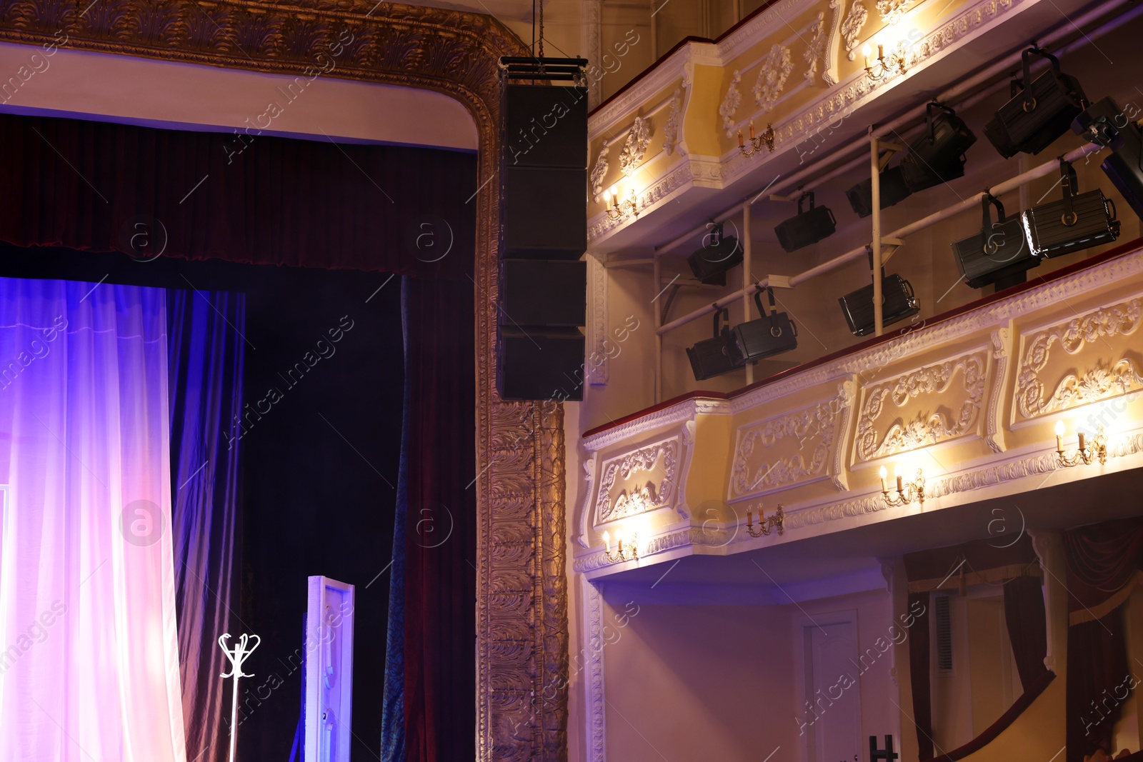 Photo of Many professional spotlights illuminating stage in theatre