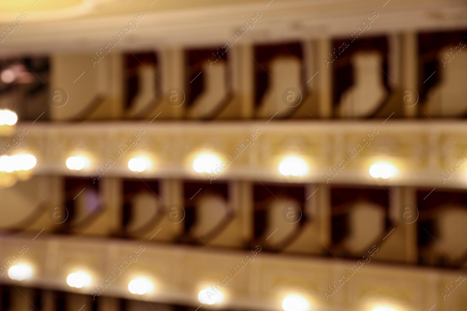 Photo of Blurred view of balconies with vintage wall lamps in theatre