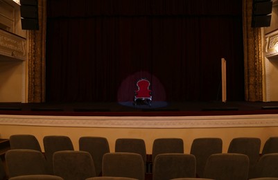 Photo of Vintage red armchair on stage in theatre