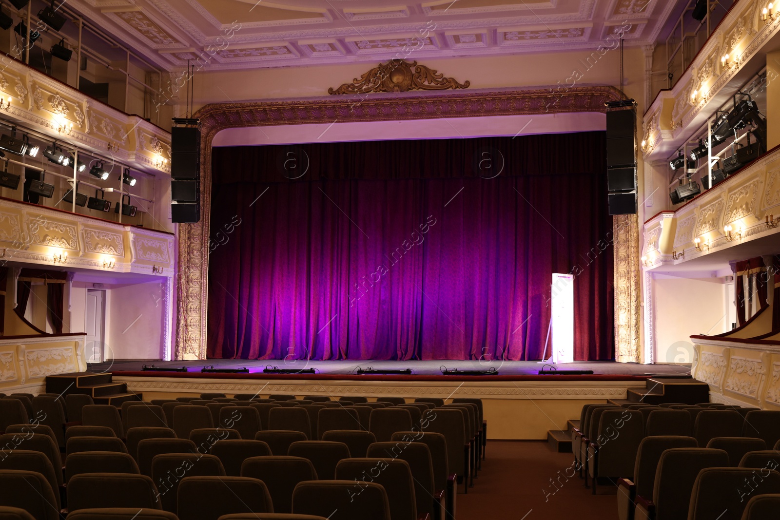 Photo of Theatre interior with stage and rows of comfortable seats