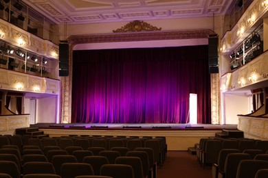 Photo of Theatre interior with stage and rows of comfortable seats