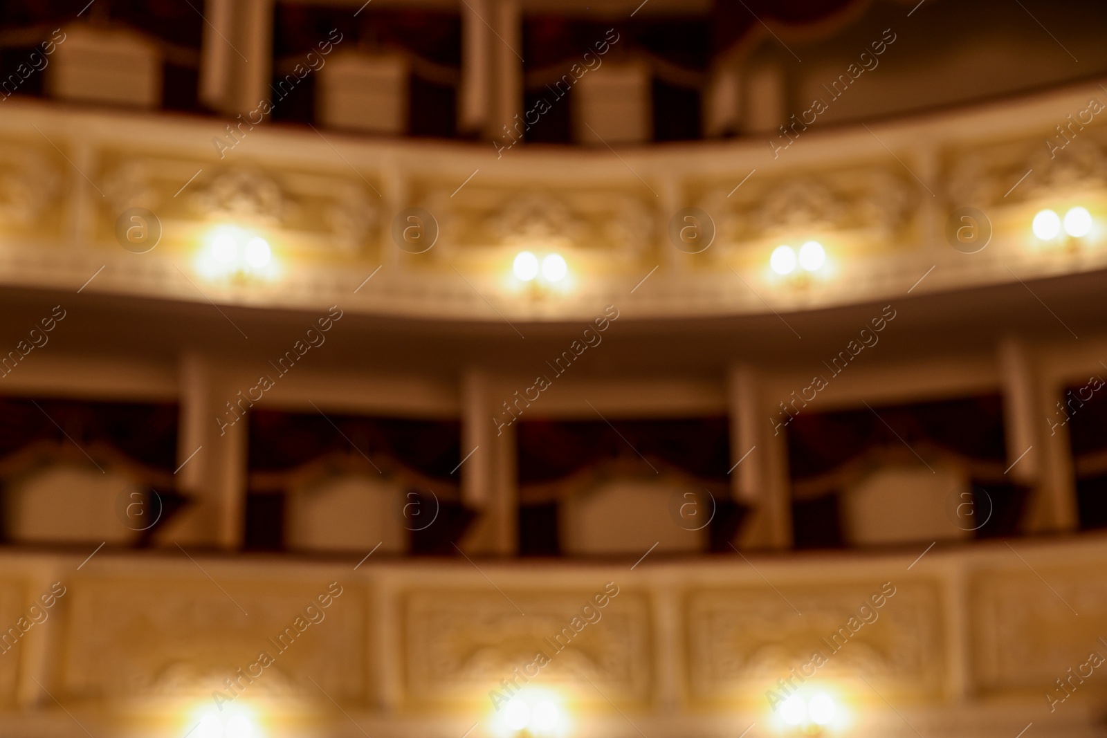 Photo of Blurred view of balconies with vintage wall lamps in theatre