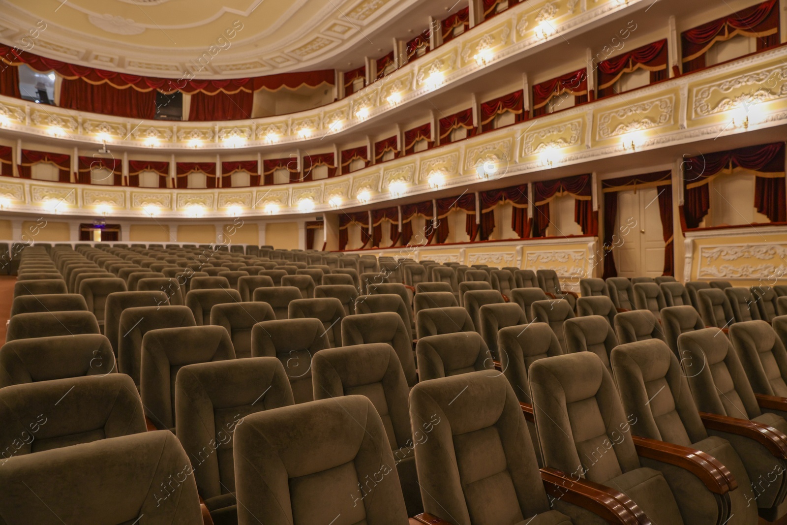 Photo of Rows of gray comfortable seats in theatre