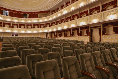 Photo of Rows of gray comfortable seats in theatre