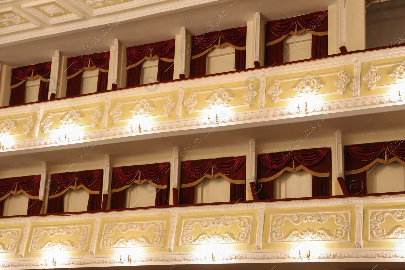 Photo of Balconies with vintage wall lamps in theatre