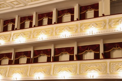 Photo of Balconies with vintage wall lamps in theatre