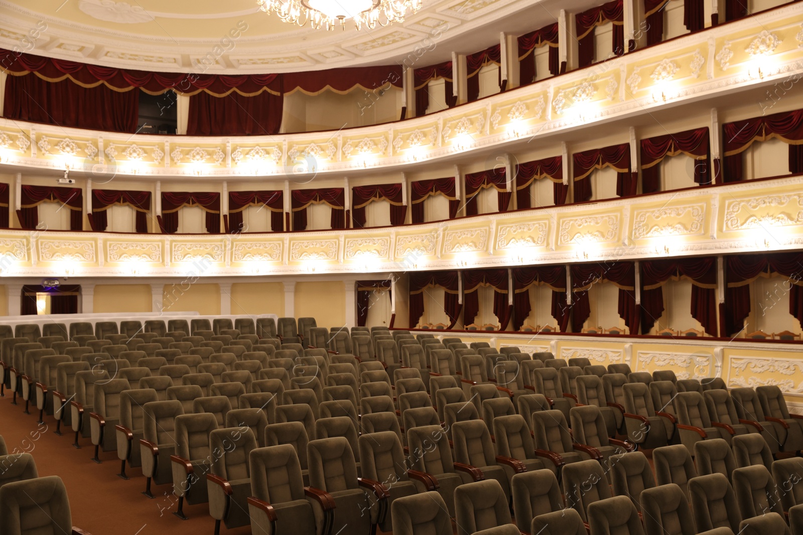 Photo of Rows of gray comfortable seats in theatre