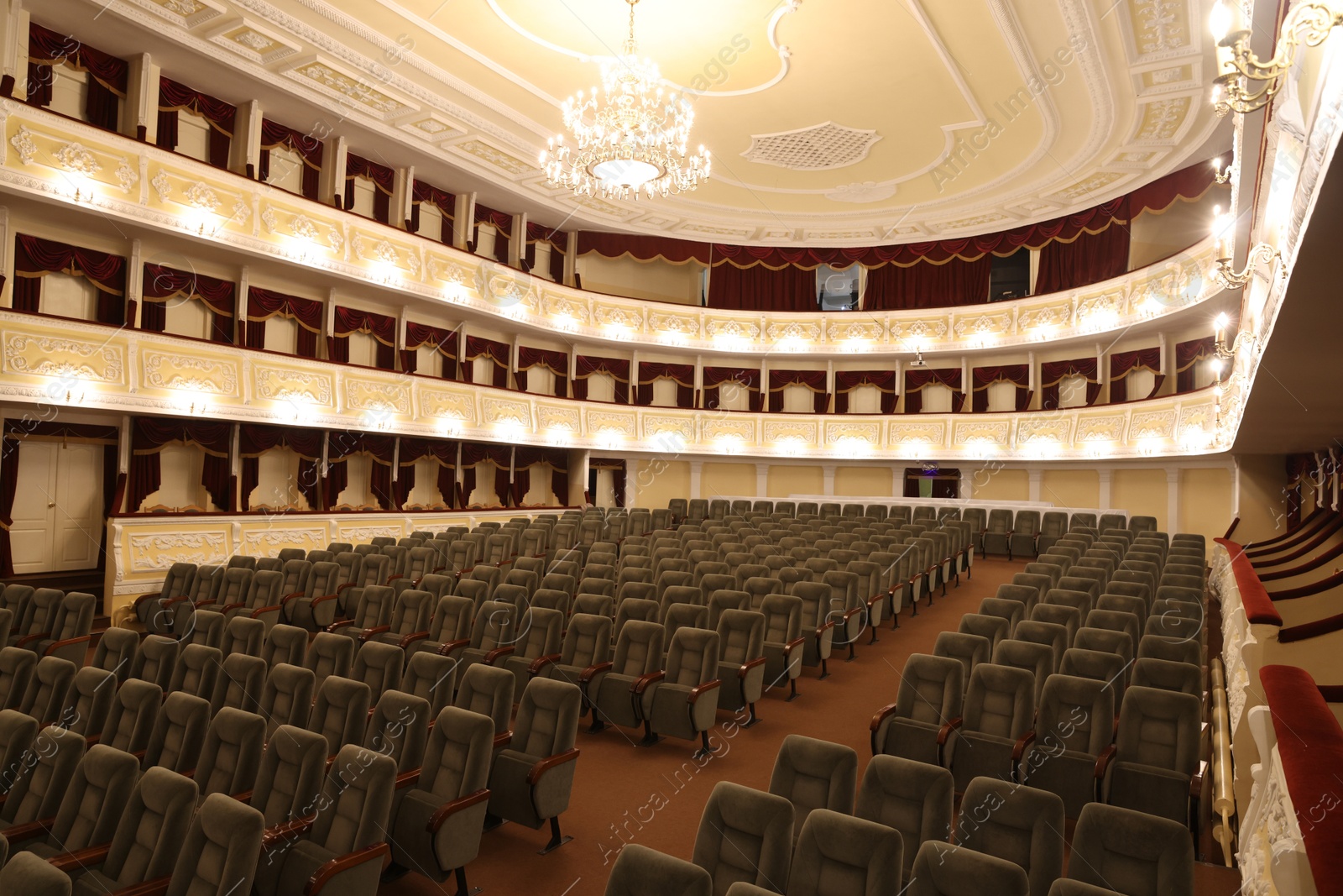 Photo of Rows of gray comfortable seats in theatre