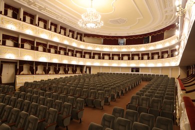 Rows of gray comfortable seats in theatre