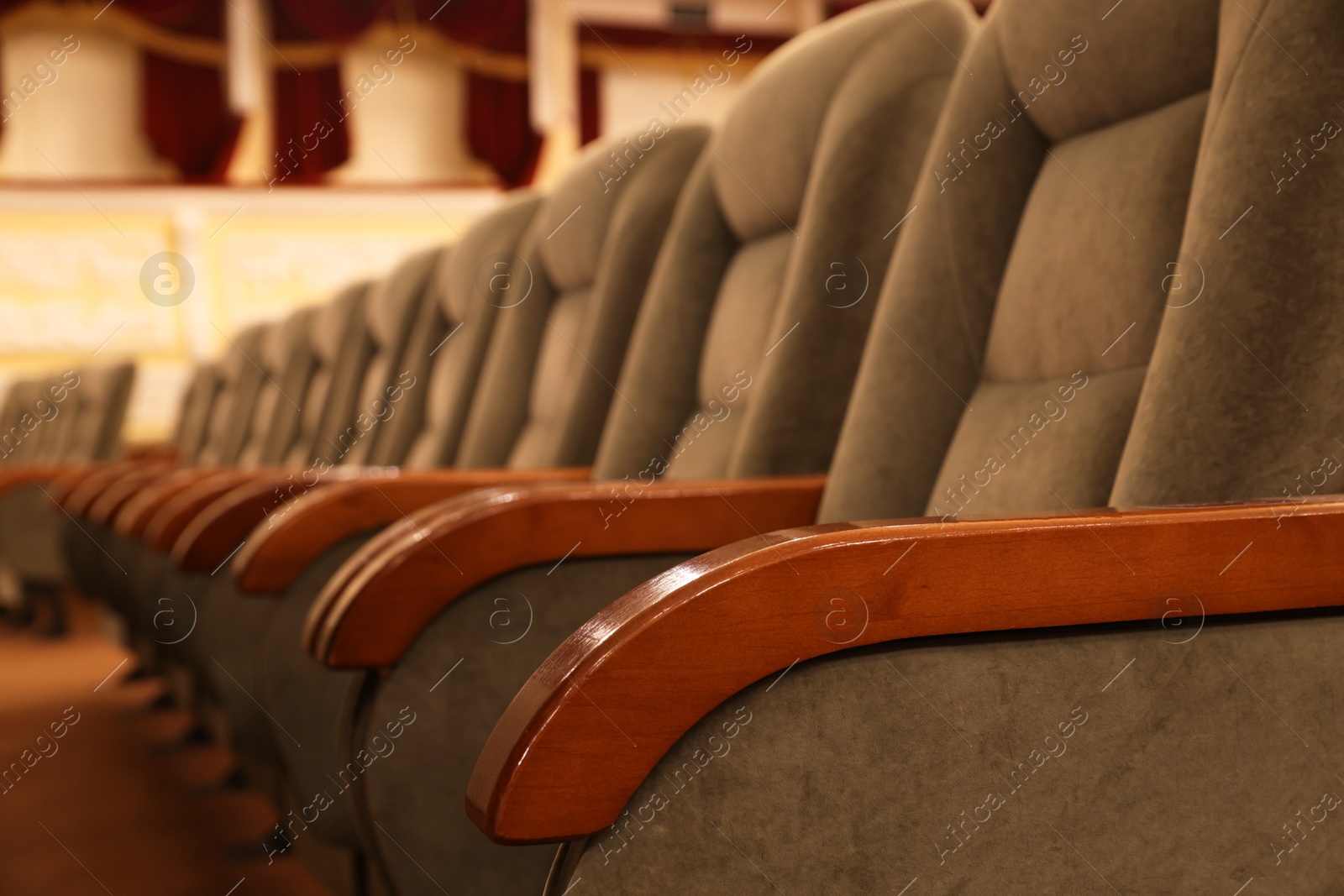 Photo of Rows of gray comfortable seats in theatre, closeup