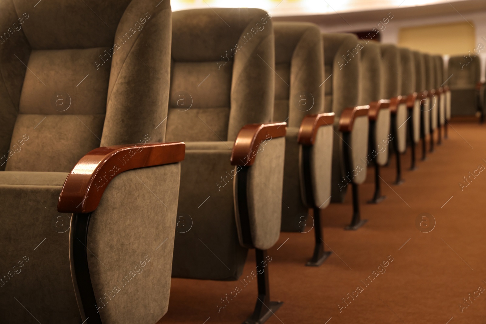 Photo of Rows of gray comfortable seats in theatre, closeup