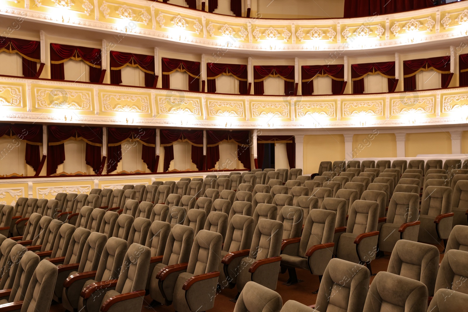 Photo of Rows of gray comfortable seats in theatre