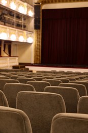 Photo of Rows of gray comfortable seats in theatre, closeup