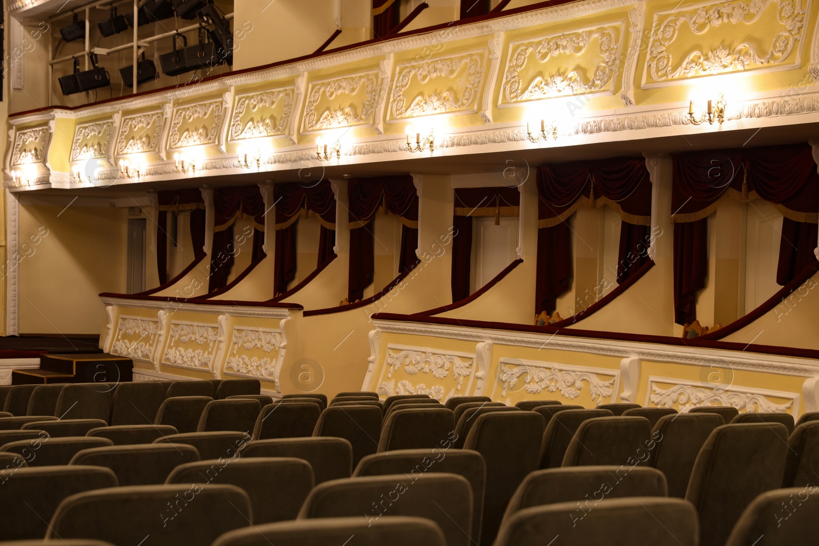 Photo of Rows of gray comfortable seats in theatre