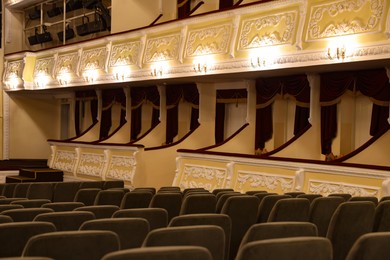 Photo of Rows of gray comfortable seats in theatre