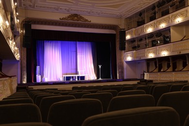 Photo of Theatre interior with stage and rows of comfortable seats