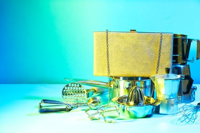 Photo of Bag and kitchen utensils on light blue background, space for text