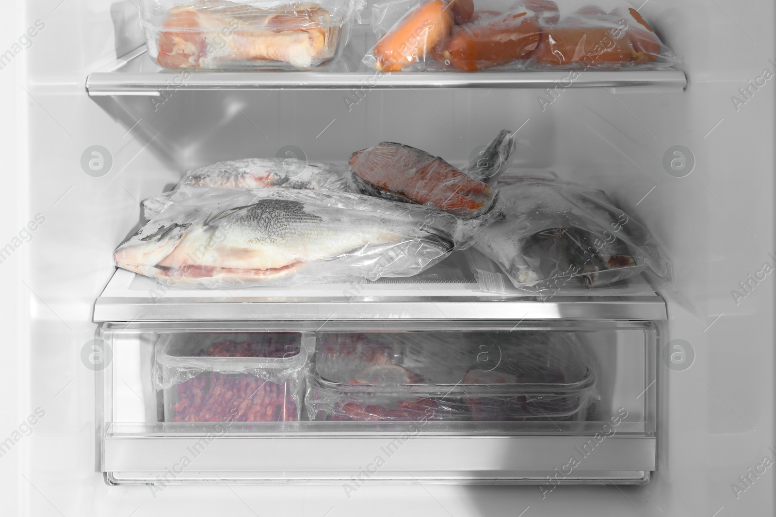 Photo of Different frozen meat and fish products in fridge