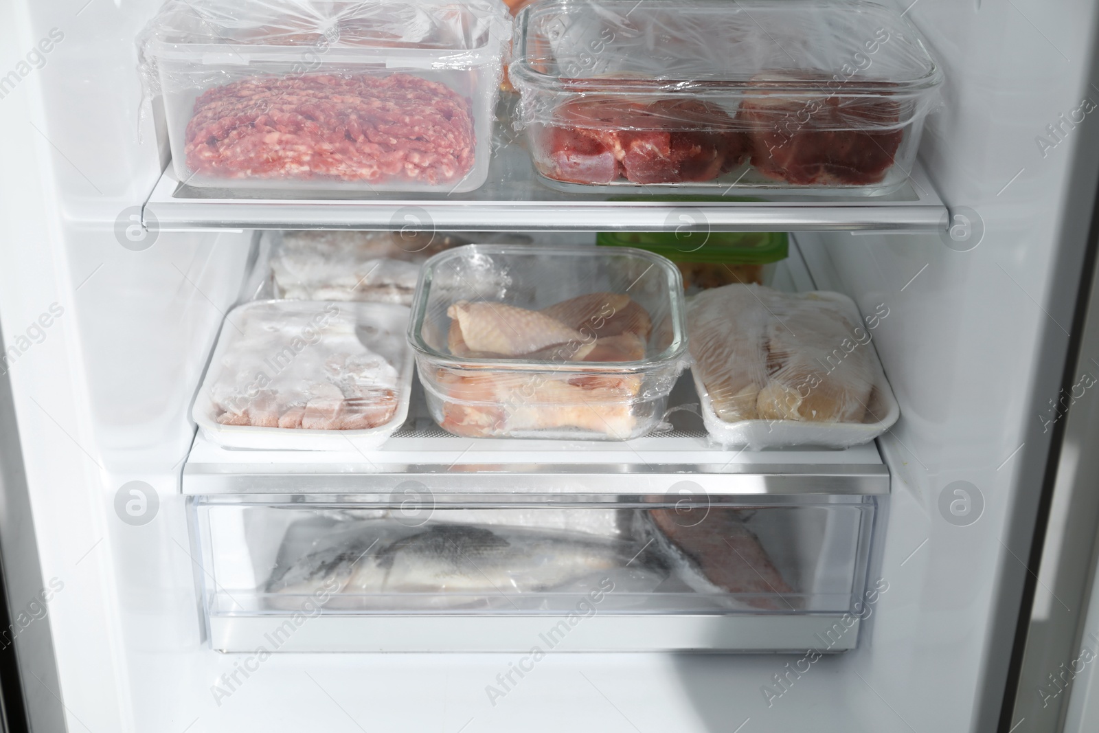 Photo of Different frozen meat and fish products in fridge