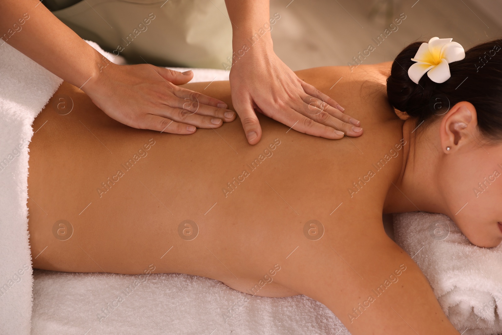 Photo of Woman receiving massage in spa salon, closeup