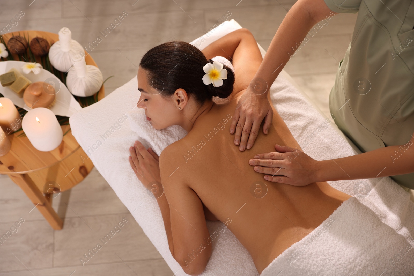 Photo of Woman receiving back massage in spa salon, top view