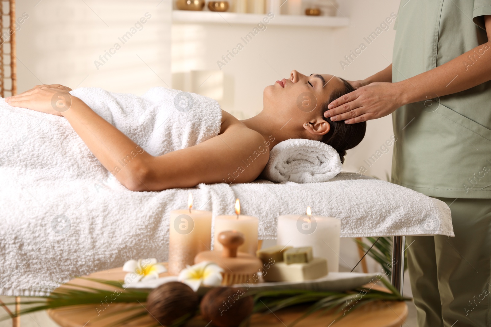 Photo of Young woman receiving massage in spa salon