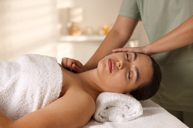 Young woman receiving massage in spa salon