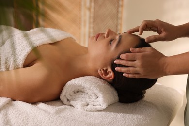 Photo of Woman receiving face massage in spa salon