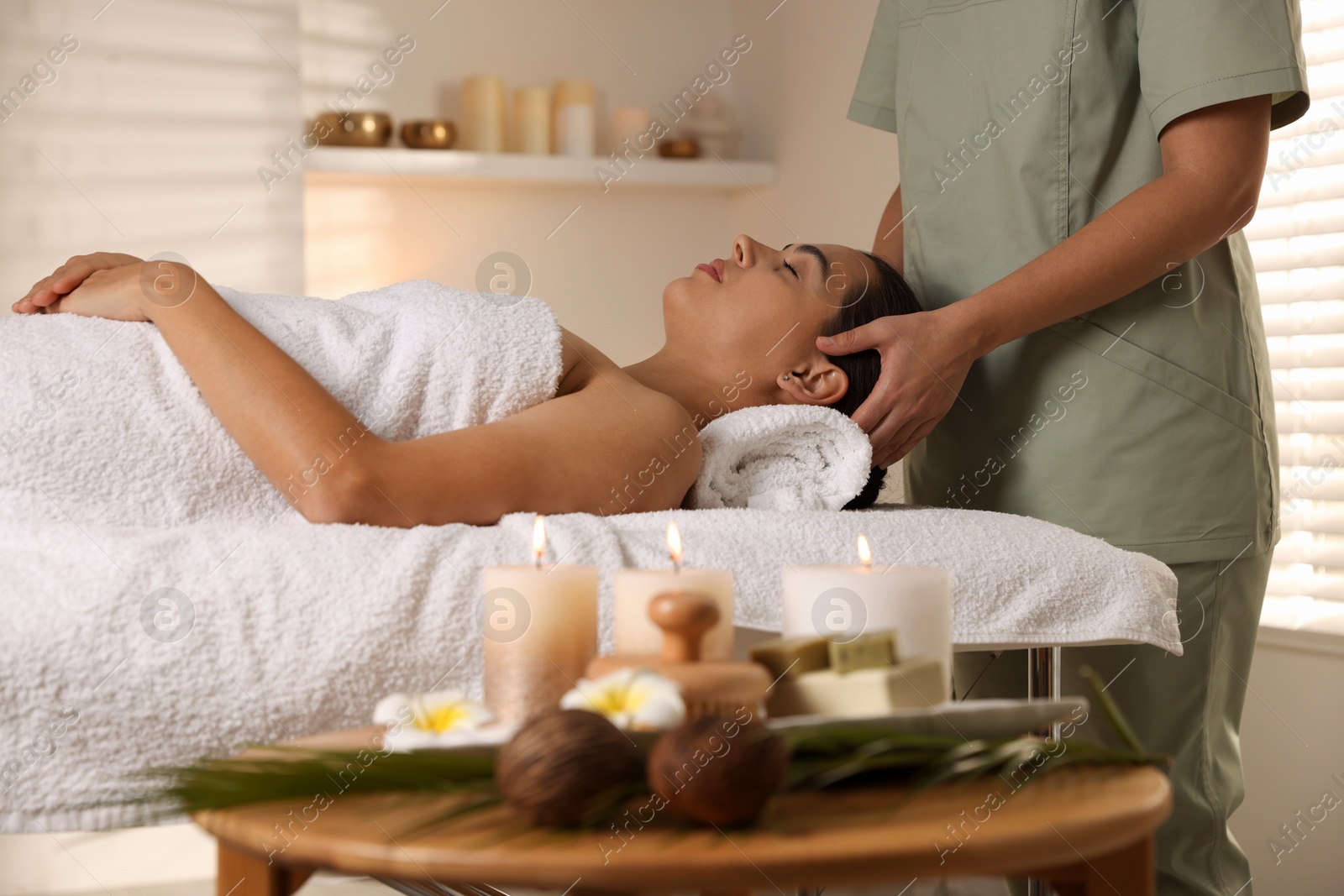 Photo of Young woman receiving massage in spa salon