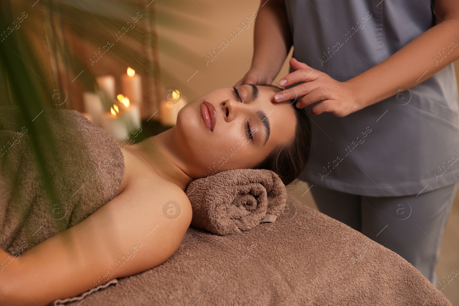 Photo of Woman receiving face massage in spa salon